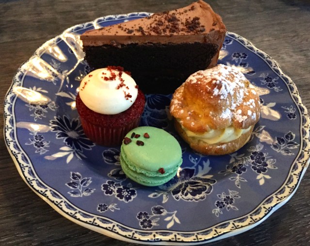 Second plate of pastries: chocolate cake, cream puff, macaron, cupcake